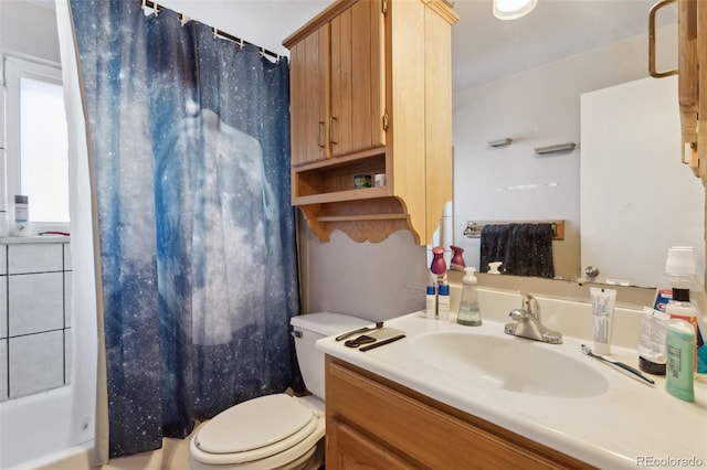 bathroom with vanity, curtained shower, and toilet