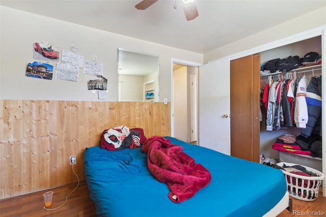 bedroom with ceiling fan, a closet, and wood-type flooring