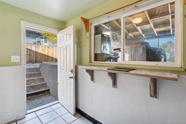 doorway to outside featuring light tile patterned flooring