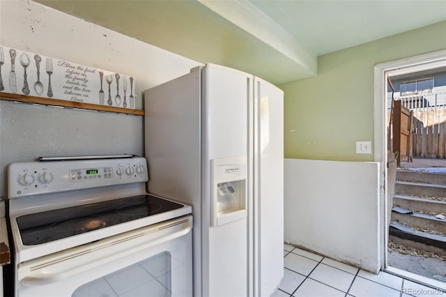 kitchen with white appliances and light tile patterned floors