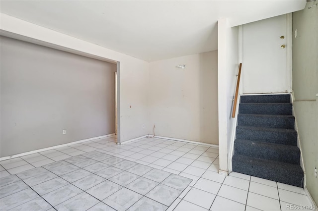 stairway featuring tile patterned flooring