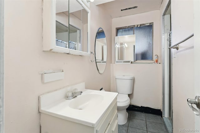 bathroom with tile patterned floors, vanity, and toilet