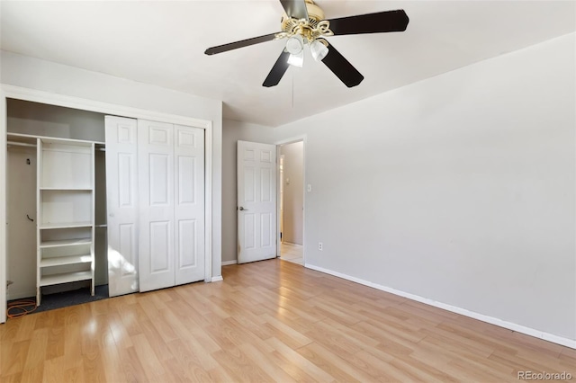 unfurnished bedroom featuring ceiling fan, a closet, and light hardwood / wood-style floors