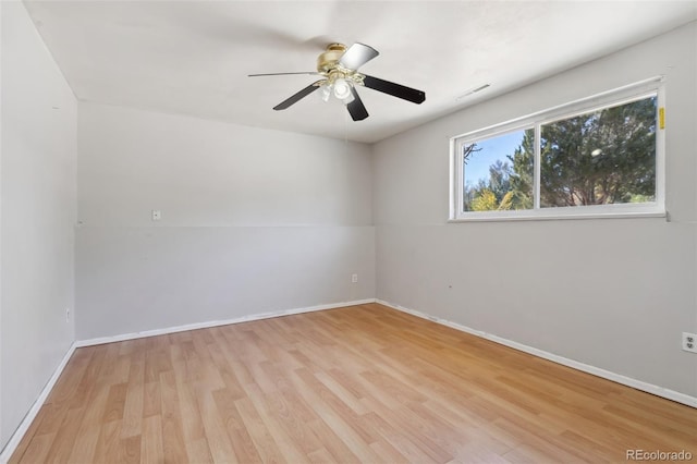 empty room with light hardwood / wood-style flooring and ceiling fan