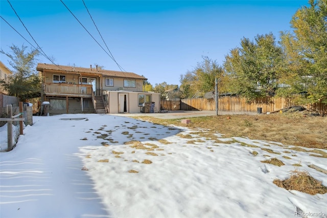 view of snow covered rear of property