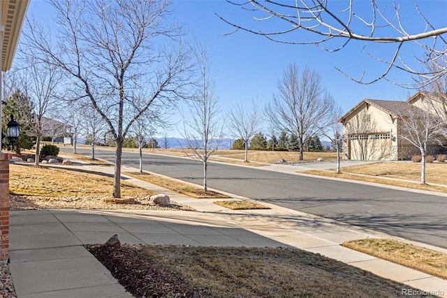 view of street with street lighting, curbs, and sidewalks