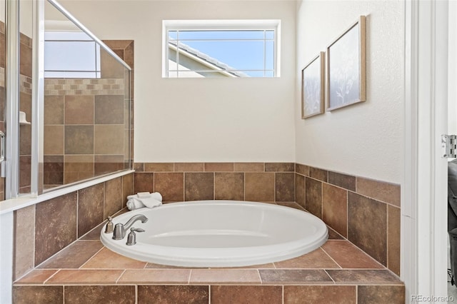 bathroom with plenty of natural light, a shower stall, and a bath