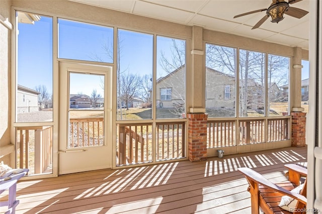 sunroom / solarium featuring plenty of natural light and ceiling fan