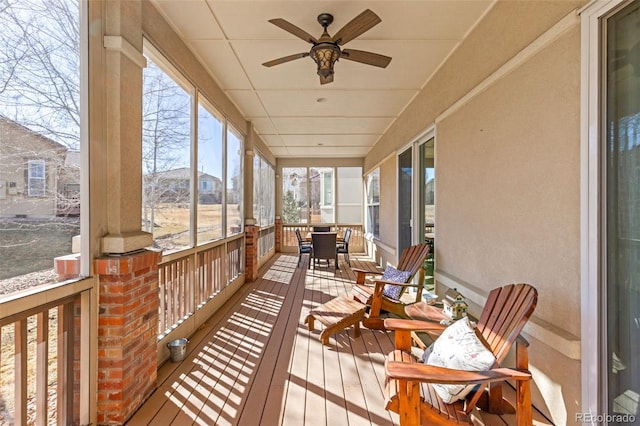 sunroom / solarium featuring ceiling fan