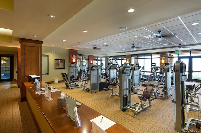 exercise room featuring a ceiling fan, recessed lighting, light colored carpet, and a drop ceiling