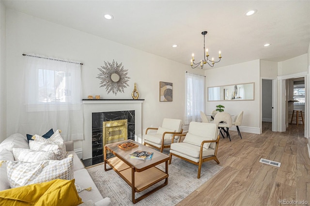 715 W 7th Ave, Denver, CO 80204 - living area with a chandelier, light wood finished floors, recessed lighting, and a premium fireplace