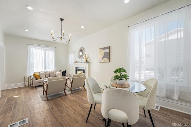 715 W 7th Ave, Denver, CO 80204 - dining room with a chandelier, wood finished floors, recessed lighting, and a fireplace