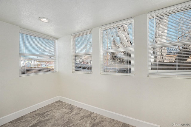 715 W 7th Ave, Denver, CO 80204 - empty room with a textured ceiling and plenty of natural light