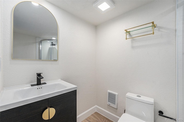 715 W 7th Ave, Denver, CO 80204 - full bathroom with heating unit, vanity, and wood finished floors