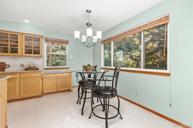 tiled dining area featuring an inviting chandelier