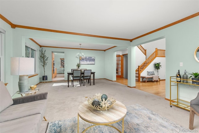 living room featuring crown molding, a chandelier, and light carpet