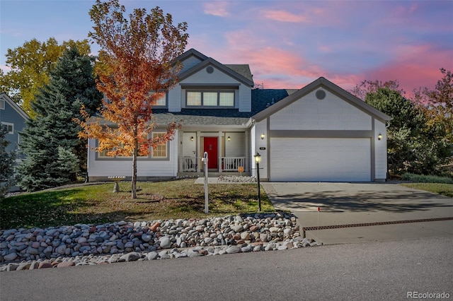 view of front of home with a garage and a lawn