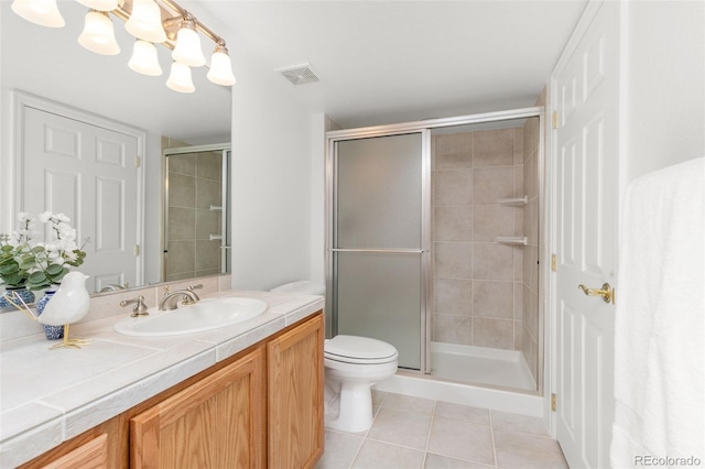 bathroom with a chandelier, tile patterned flooring, vanity, an enclosed shower, and toilet