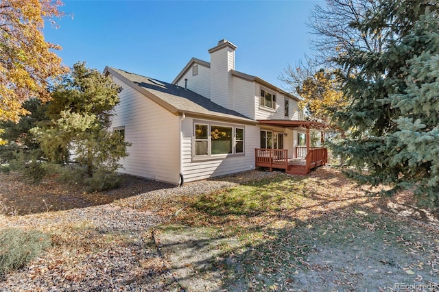 rear view of house with a wooden deck