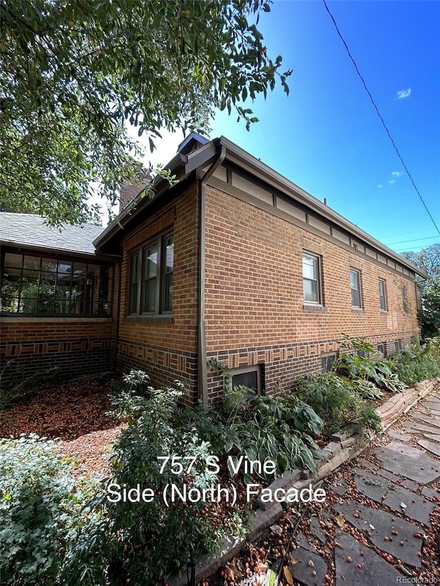 view of property exterior featuring a sunroom