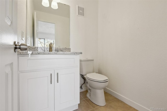 bathroom with toilet, vanity, tile patterned floors, and a textured ceiling