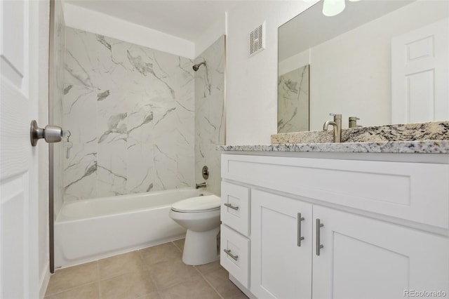 full bathroom featuring tiled shower / bath combo, vanity, toilet, and tile patterned flooring