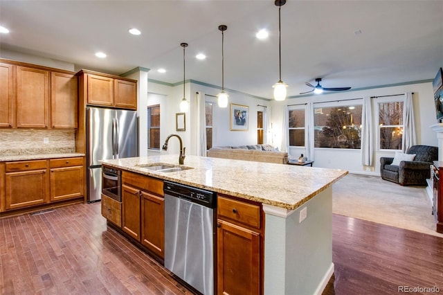 2415 Bluestem Willow Dr, Loveland, CO 80538 - kitchen with appliances with stainless steel finishes, open floor plan, a sink, ceiling fan, and ornamental molding