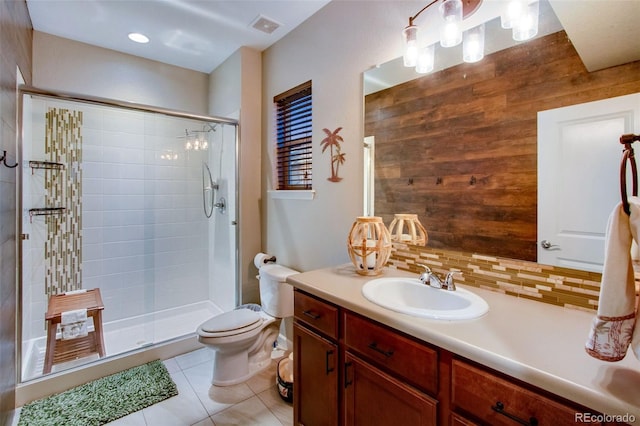 2415 Bluestem Willow Dr, Loveland, CO 80538 - bathroom featuring vanity, toilet, a shower stall, tile patterned floors, and backsplash