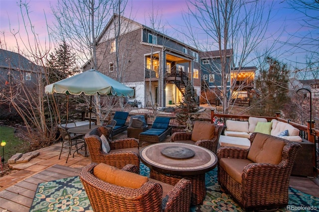 2415 Bluestem Willow Dr, Loveland, CO 80538 - wooden terrace featuring an outdoor living space with a fire pit, a patio area, and stairway