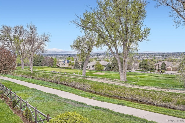 view of property's community featuring a yard and a residential view