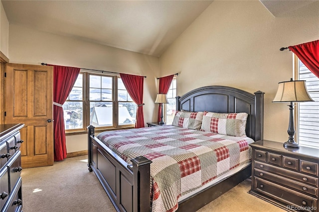 bedroom featuring baseboards, carpet floors, and vaulted ceiling