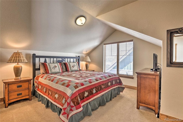 carpeted bedroom featuring baseboards and lofted ceiling