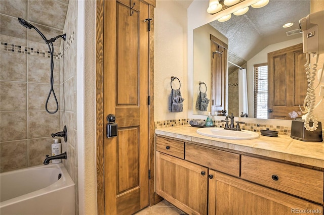 full bath featuring visible vents, shower / bath combination, lofted ceiling, a textured ceiling, and vanity