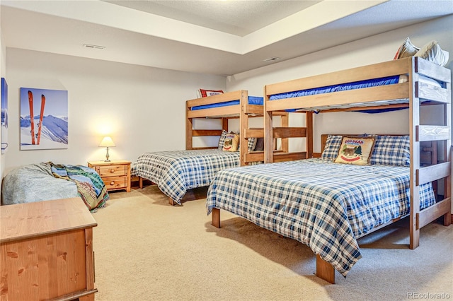 carpeted bedroom featuring visible vents