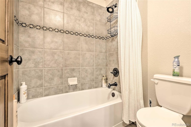 full bath featuring toilet, a textured wall, and shower / bathtub combination with curtain