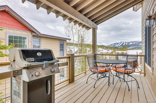 wooden deck featuring a mountain view and area for grilling