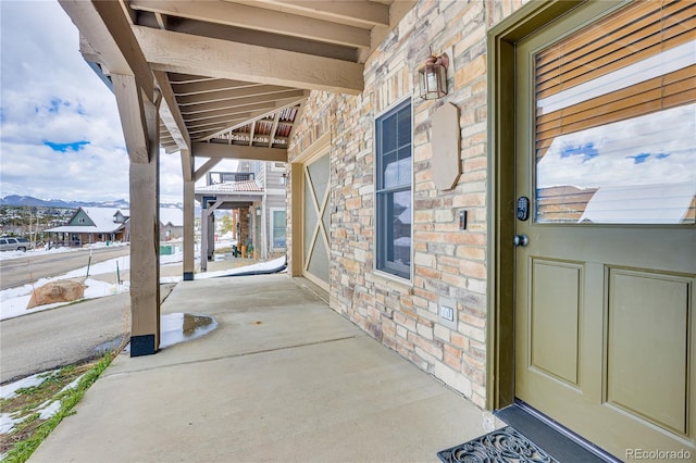 view of exterior entry with brick siding and stone siding