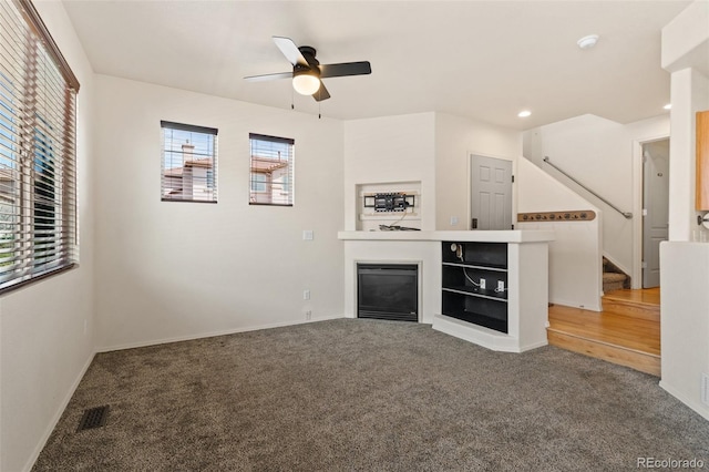 7046 Sand Crest Vw, Colorado Springs, CO 80923 - unfurnished living room with healthy amount of natural light, a ceiling fan, carpet, and recessed lighting