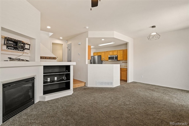 7046 Sand Crest Vw, Colorado Springs, CO 80923 - unfurnished living room featuring carpet, ceiling fan, recessed lighting, a glass covered fireplace, and baseboards