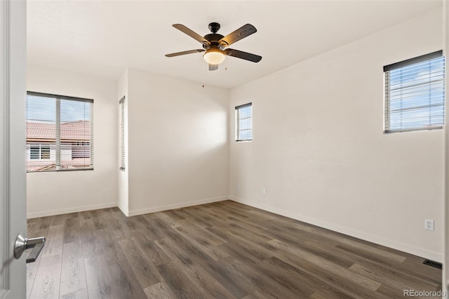 7046 Sand Crest Vw, Colorado Springs, CO 80923 - unfurnished room with healthy amount of natural light, ceiling fan, dark wood-type flooring, and baseboards
