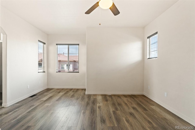 7046 Sand Crest Vw, Colorado Springs, CO 80923 - empty room featuring wood finished floors, a ceiling fan, baseboards, and arched walkways