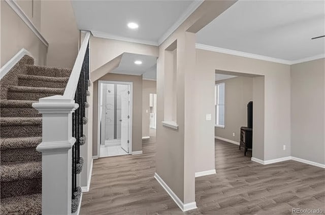 1021 Lake Ave, Pueblo, CO 81004 - foyer with crown molding, wood finished floors, stairs, baseboards, and recessed lighting