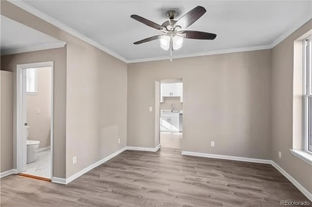 1021 Lake Ave, Pueblo, CO 81004 - unfurnished room featuring a ceiling fan, ornamental molding, wood finished floors, and baseboards
