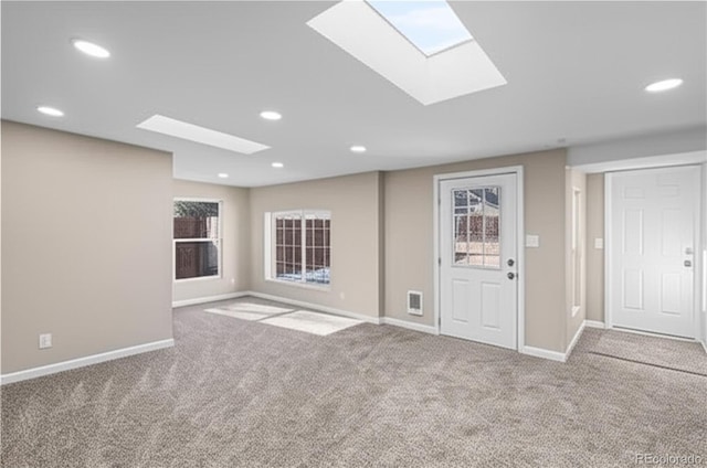 1021 Lake Ave, Pueblo, CO 81004 - empty room featuring carpet, a skylight, baseboards, and recessed lighting