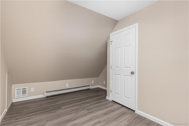 1021 Lake Ave, Pueblo, CO 81004 - bonus room featuring baseboard heating, wood finished floors, lofted ceiling, and baseboards