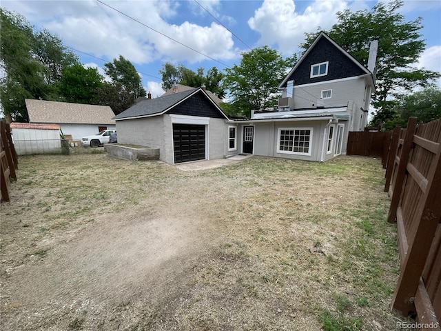 1021 Lake Ave, Pueblo, CO 81004 - rear view of property featuring a chimney, a garage, and dirt driveway