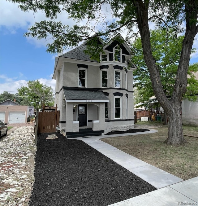 1021 Lake Ave, Pueblo, CO 81004 - view of front of property with roof with shingles, brick siding, and a garage