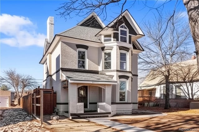 1021 Lake Ave, Pueblo, CO 81004 - view of front facade featuring a chimney, covered porch, and brick siding