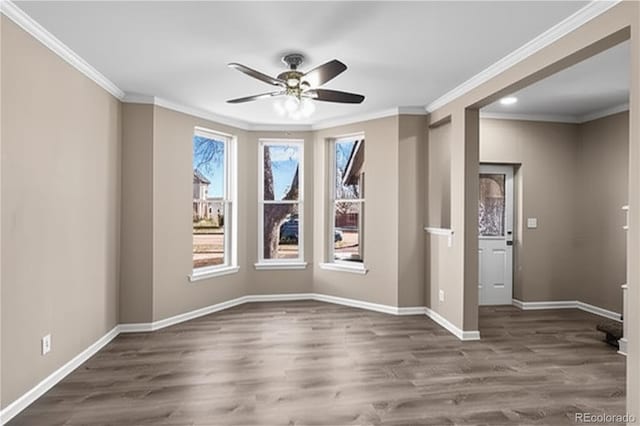 1021 Lake Ave, Pueblo, CO 81004 - spare room with ornamental molding, ceiling fan, wood finished floors, and baseboards