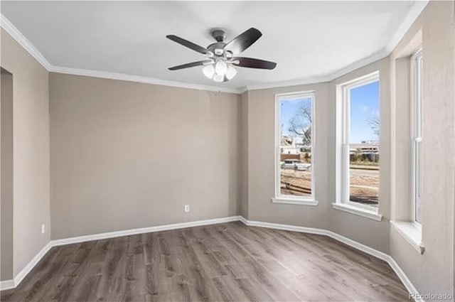 1021 Lake Ave, Pueblo, CO 81004 - empty room with ornamental molding, wood finished floors, ceiling fan, and baseboards